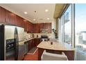 Modern kitchen with stainless steel appliances, granite countertops, and city views at 855 Peachtree Ne St # 2412, Atlanta, GA 30308