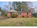 Brick ranch-style home with a front yard, bushes, and decorative statue at 2649 Toni Sw Pl, Marietta, GA 30060