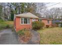 Single-story brick home with bushes, a driveway, and a front yard at 2649 Toni Sw Pl, Marietta, GA 30060