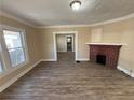 Living room with fireplace and wood-look floors at 126 Wellington Sw St, Atlanta, GA 30314