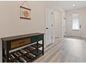 Welcoming entryway with wood-look flooring and a console table at 3934 Saddle Bag Ct, Dacula, GA 30019