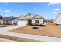 Inviting two-story home with a two-car garage and a landscaped front yard at 3934 Saddle Bag Ct, Dacula, GA 30019