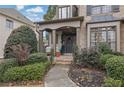 Inviting front porch with holiday decor and a well-maintained lawn at 1680 Holcomb Lake Rd, Marietta, GA 30062