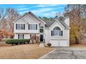 Inviting two-story home with a two-car garage, stone accents, and a landscaped front yard at 219 Regency Ct, Acworth, GA 30102