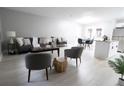 Open concept living and dining area with modern furniture, neutral colors, and light gray walls at 4001 Red Oak Dr, Atlanta, GA 30340