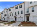 A row of modern white townhouses with attached garages and black accents at 148 Werner Brook Sw Way, Atlanta, GA 30354