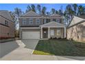 Beautiful two-story home with a brick and siding facade, covered front porch, and a two-car garage at 109 Belvedere Rd, Mcdonough, GA 30253