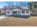 Newly renovated ranch home with a blue front door at 7017 Ray St, Riverdale, GA 30274