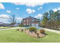 Landscaped front yard with a large brick house at 1268 Windsor Glen Dr, Douglasville, GA 30134