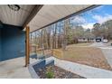 Front porch view of the home with wooden railing and stairs at 26 Alisha Nw Cir, Cartersville, GA 30121