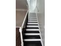 A staircase with dark stained steps and white railings leading to the second floor at 941 Capitol View Ave, Atlanta, GA 30318