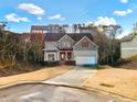 Two-story home with a driveway, front yard, and trees at 264 Creek View Pl, Canton, GA 30114