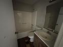 Bathroom with shower/tub combo, vanity sink, and wood-look floor at 4262 Catalpa Park, Ellenwood, GA 30294