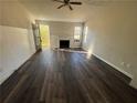 Living room featuring a fireplace, dark wood-look floors, and natural light at 4262 Catalpa Park, Ellenwood, GA 30294