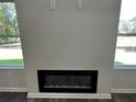 Modern linear fireplace with black surround and glass front at 45 Heyman Dr, Covington, GA 30016