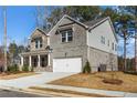 Attractive two-story residence with a mixed siding exterior and a covered entryway at 1495 Auburn Glen Rd, Dacula, GA 30019