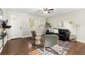 Living room with wood floors, black leather sofa, and two accent chairs at 944 Liberty Hill Ne Rd, Marietta, GA 30066