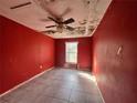Red bedroom with tile flooring, ceiling fan, and window at 202 Hayes St, Villa Rica, GA 30180