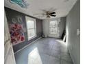 Bedroom with tile flooring, ceiling fan, and two windows at 202 Hayes St, Villa Rica, GA 30180