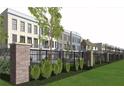 Townhome community with brick and iron fence, landscaping, and green space at 531 S Main St # 210, Alpharetta, GA 30009