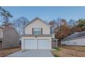 Two-story home with two-car garage and a small front yard at 5901 Bluegrass Vw, Fairburn, GA 30213