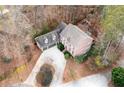 An aerial view of a two-story home with a three-car garage and wooded lot at 201 Rippling Nw Dr, Marietta, GA 30064