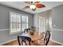 Dining area with a round wooden table, black chairs, and a ceiling fan with light at 4545 Canterbury Dr, Cumming, GA 30040