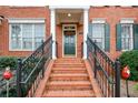 Close-up view of the brick steps and elegant front door with holiday wreath at 4754 Ivy Ridge Se Dr # 1, Atlanta, GA 30339