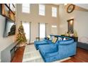 Spacious living room with hardwood floors, high ceilings, and a large sectional sofa at 4754 Ivy Ridge Se Dr # 1, Atlanta, GA 30339