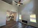 Open living room with high ceilings, fireplace, and view of the kitchen at 5555 Bent Grass Way, Douglasville, GA 30135