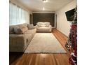 Living room with hardwood floors, a large rug, two sofas, and a TV at 1393 Bolton Nw Rd, Atlanta, GA 30331