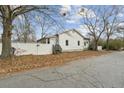 Single-story home with white siding, fenced yard, and trees at 6214 Hagin St, Douglasville, GA 30134