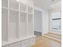 Entryway with white built-in cubbies and bench with drawers and hardwood flooring at 1332 Koa Se Ct # 100, Smyrna, GA 30080