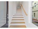 Staircase with wooden treads and white risers, leading to the upper level, with a window at 1332 Koa Se Ct # 100, Smyrna, GA 30080