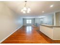 Open dining room with hardwood floors and a chandelier, adjacent to the kitchen at 3930 Wedgefield Cir, Decatur, GA 30035