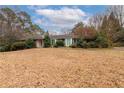 One-story home with a spacious front yard and some trees at 750 Mount Vernon Hwy, Atlanta, GA 30327