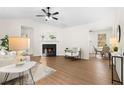 Inviting living room featuring a fireplace, wood-look flooring, and ample natural light at 247 Mandy Ct, Mcdonough, GA 30252