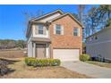 Two-story brick home with attached garage and manicured lawn at 5237 Halcyon Ct, Morrow, GA 30260