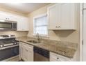 Modern kitchen featuring stainless steel appliances, white shaker cabinets, and granite countertops at 453 Utoy Sw Cir, Atlanta, GA 30331