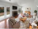 Bright living room with a brick fireplace, French doors, and stylish furniture at 4727 Garden Hills Dr, Stone Mountain, GA 30083