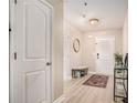 Bright entryway with light wood-look flooring, a bench, and decorative rug at 2137 Belmont Cir, Conyers, GA 30012