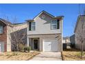 Inviting two-story home featuring a one-car garage and landscaped yard at 2137 Belmont Cir, Conyers, GA 30012