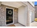 Welcoming front entrance with a black door, festive wreath, and brick exterior at 2137 Belmont Cir, Conyers, GA 30012