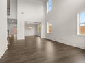 Living room with high ceilings, wood-style flooring, and adjacent dining area at 3834 Kastler Dr, South Fulton, GA 30349