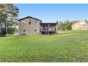 Backyard view showcasing a spacious lawn and elevated deck at 680 Horsley Mill Rd, Carrollton, GA 30116