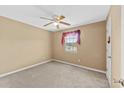 Cozy bedroom with neutral walls, carpeted floors, and ceiling fan at 680 Horsley Mill Rd, Carrollton, GA 30116