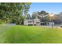 Single-Gathering home with fenced yard, covered carport, and lush green lawn at 680 Horsley Mill Rd, Carrollton, GA 30116