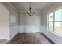 Bright dining room with hardwood floors and wainscoting at 5537 Union Pointe Pl, Union City, GA 30291
