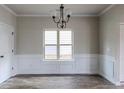 Dining room features hardwood floors and a chandelier at 5537 Union Pointe Pl, Union City, GA 30291