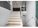 View of the entryway and staircase with a loft area overlooking the living room at 345 Panhandle Pl, Hampton, GA 30228